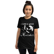 Load image into Gallery viewer, A woman is wearing a black graphic tee with a white silhouette of a murder of crows with the words "I love a good Murder"
