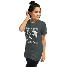 Load image into Gallery viewer, A woman is wearing a heather gray graphic tee with a white silhouette of a murder of crows with the words "I love a good Murder" shown from the left side.