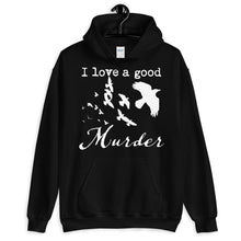 Load image into Gallery viewer, A black hoodie with a white silhouette of a murder of crows in it with the words, "I love a good Murder" hangs on a hanger from a peg.
