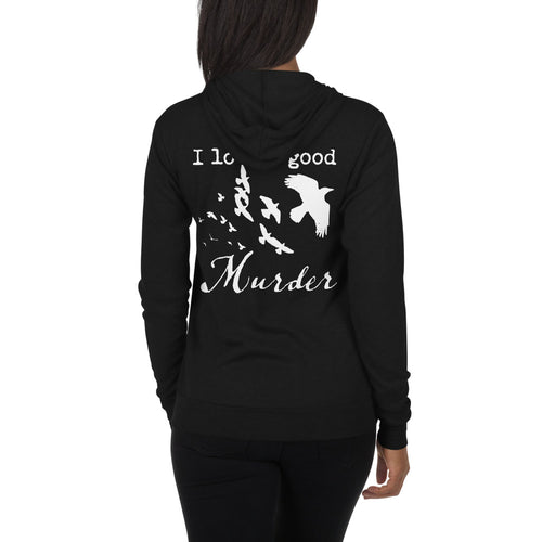 A woman is wearing a black zip hoodie with white silhouettes of a murder of crows with the words, 